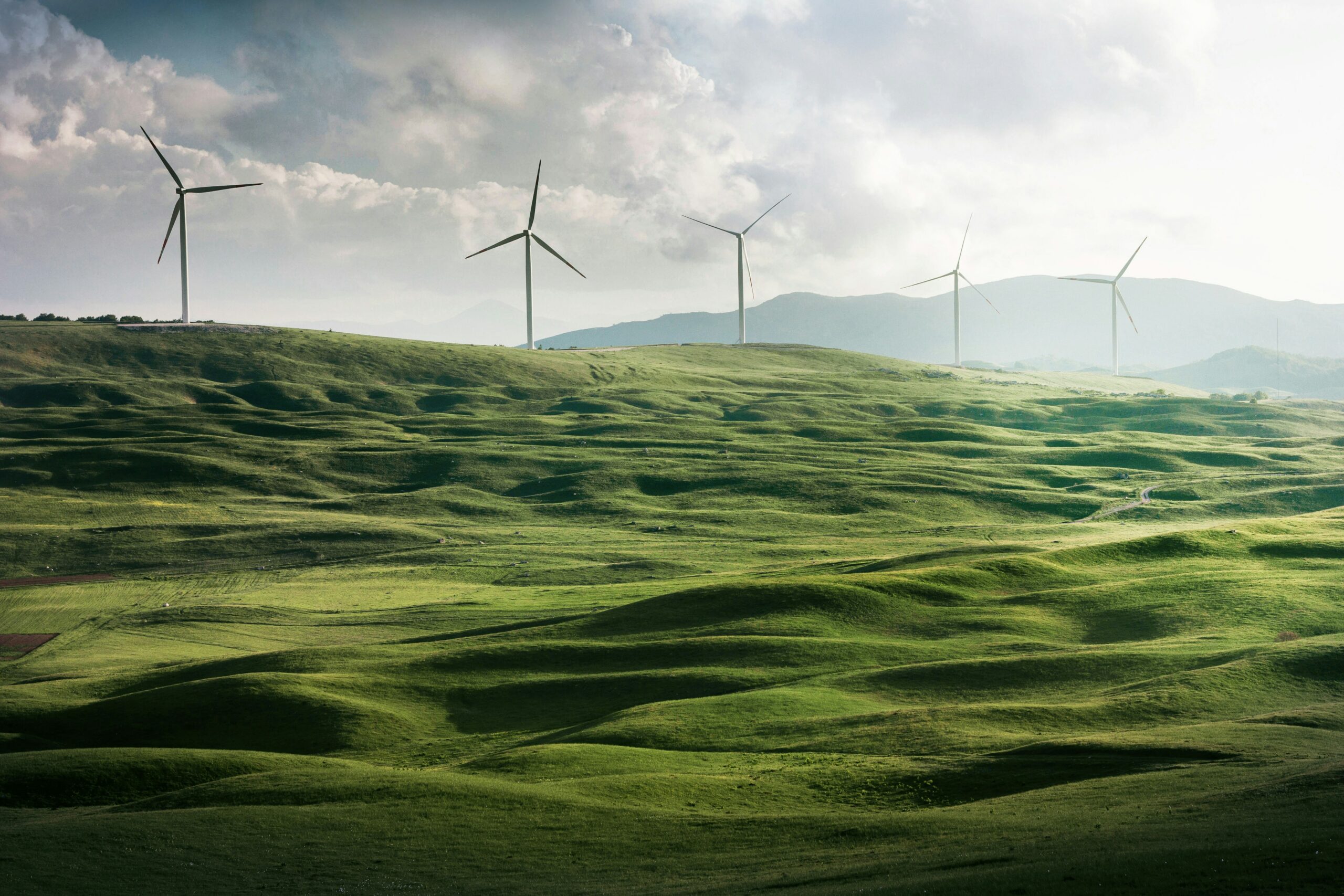 Photo by Appolinary Kalashnikova on <a href="https://unsplash.com/photos/wind-turbine-surrounded-by-grass-WYGhTLym344?utm_content=creditCopyText&utm_medium=referral&utm_source=unsplash">Unsplash</a>